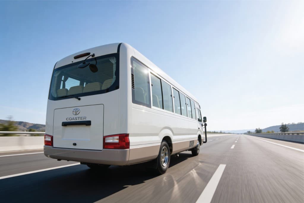 Toyota Coaster tourist coach on a Bangladesh highway, available to hire from Dhaka